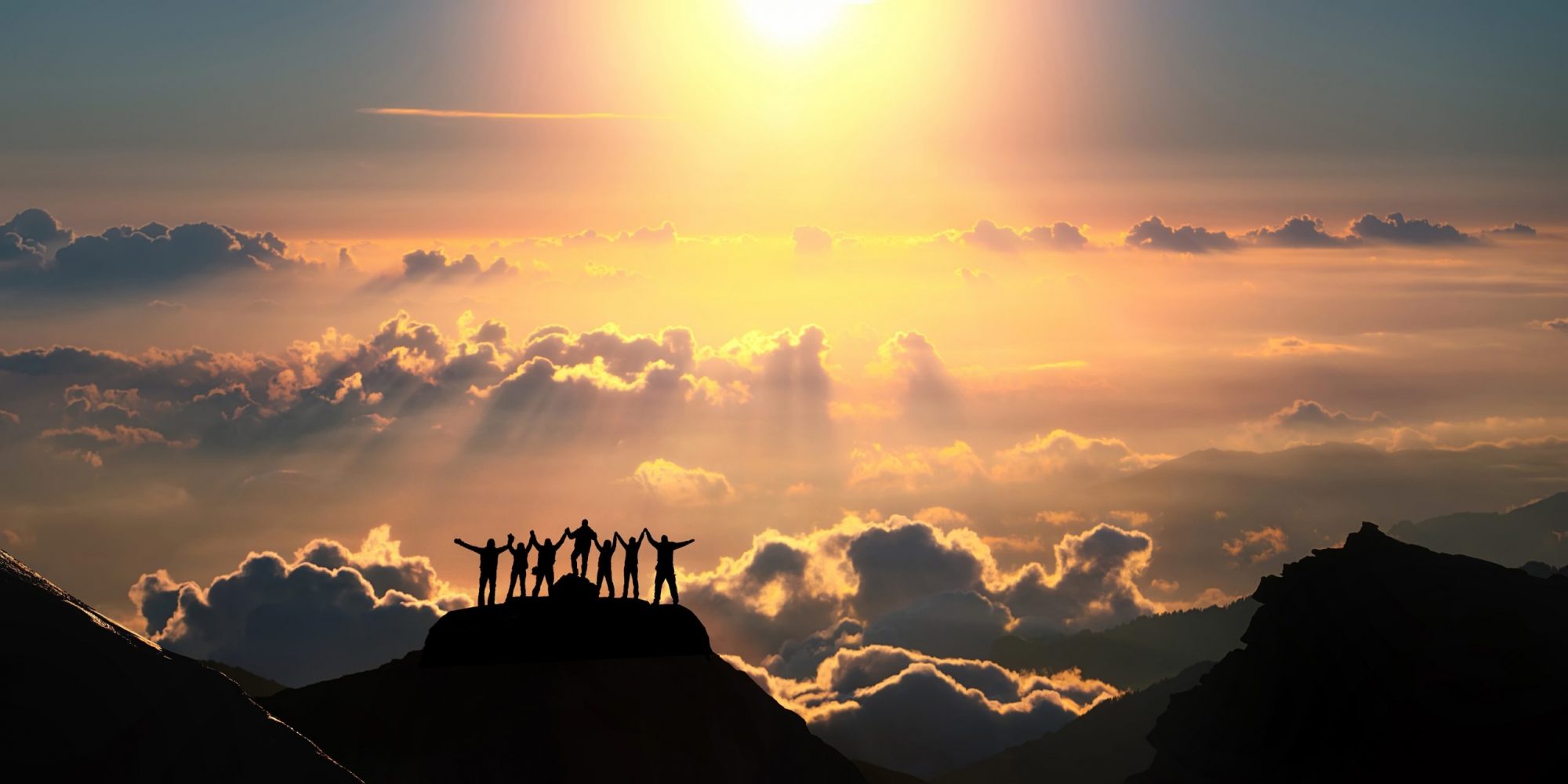 People on mountain in sunset About us scaled