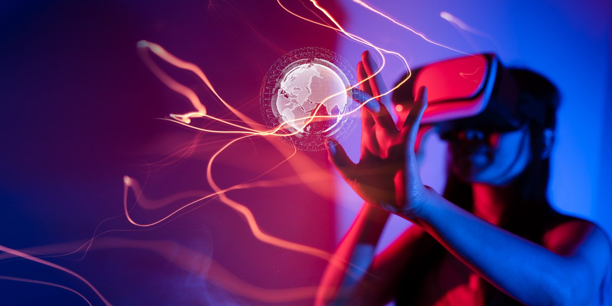 Young,Woman,Using,Glasses,Of,Virtual,Reality,On,Dark,Background. Young woman using glasses of virtual reality on dark background. Smartphone using with VR headset,virtual reality,future technology concept.Asian woman using VR glasses in colorful neon lights.