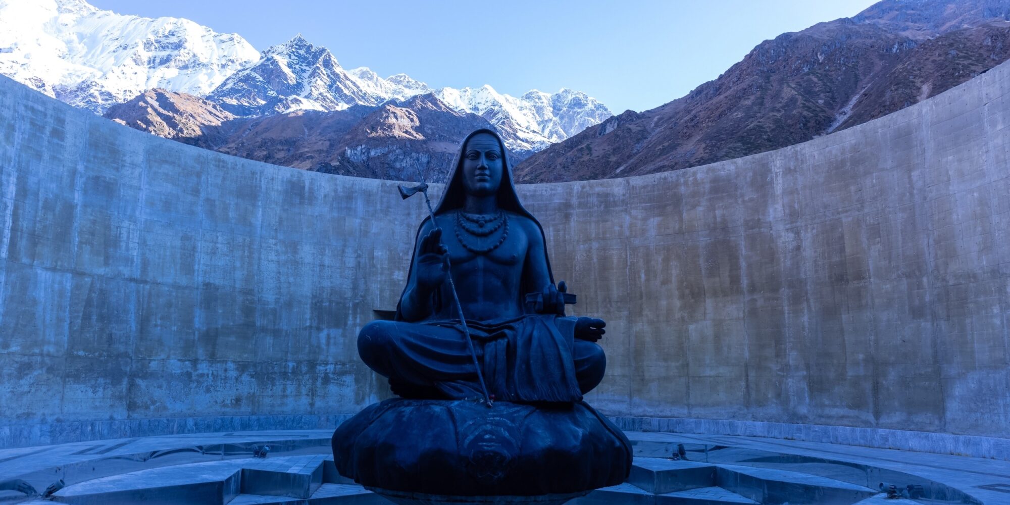 Kedarnath, Uttarakhand, India, October, 2022: 12-foot high statue of Adi Shankaracharya made of chlorite schist, and weighing 35 tons, installed behind the Kedarnath Shiva temple.