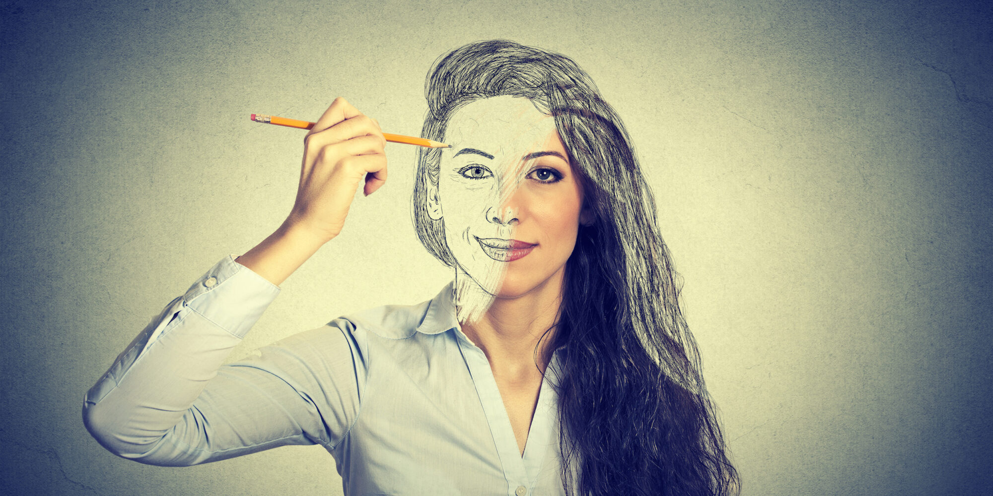 beautiful woman drawing self portrait with pencil