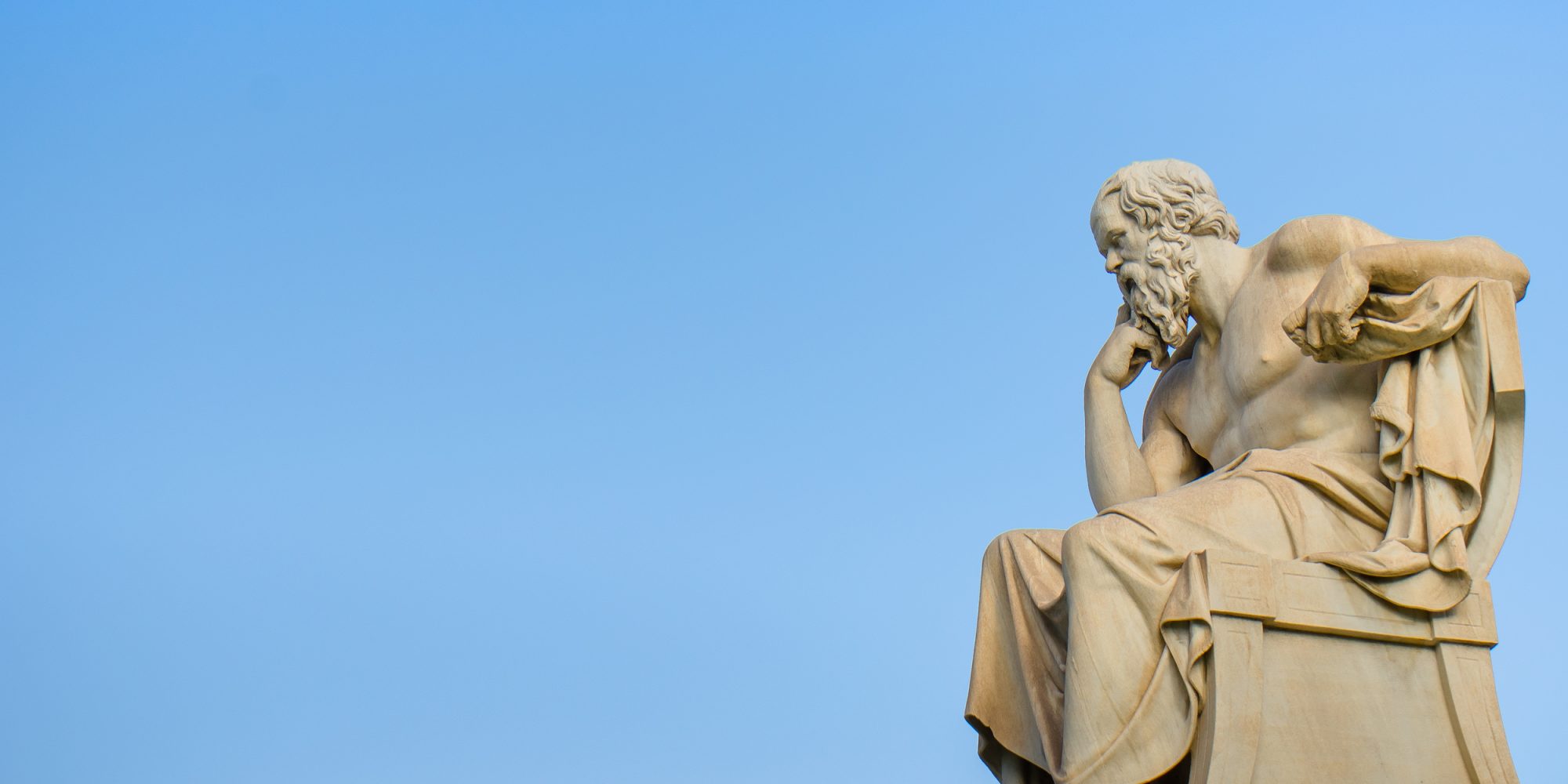 Ancient marble statue of the great Greek philosopher Socrates on background the blue sky.